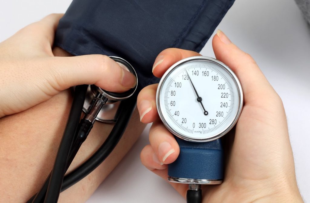 Doctor measuring blood pressure of a patient